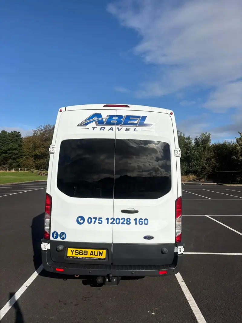 Back doors of the minibus with the Abel Travel logo and phone number 075 12028 160